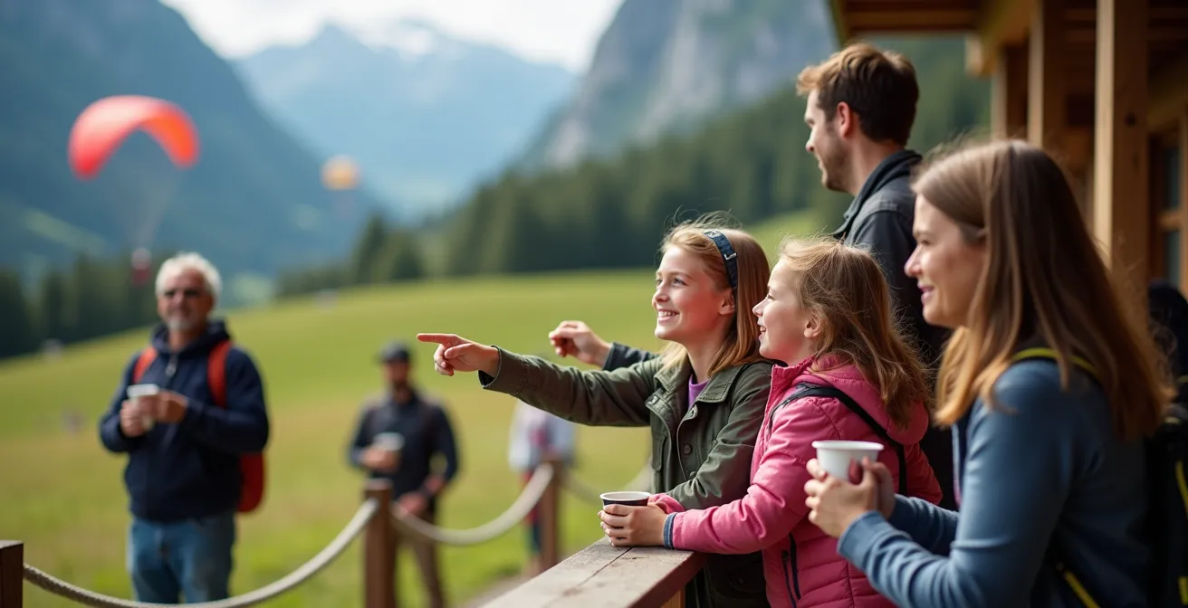 Terrasse d'observation avec familles regardant des parachutistes atterrir sur une dropzone suisse